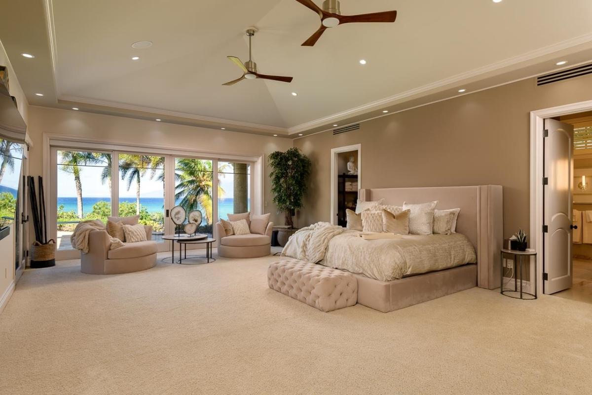Bedroom with a large bed and carpet flooring.