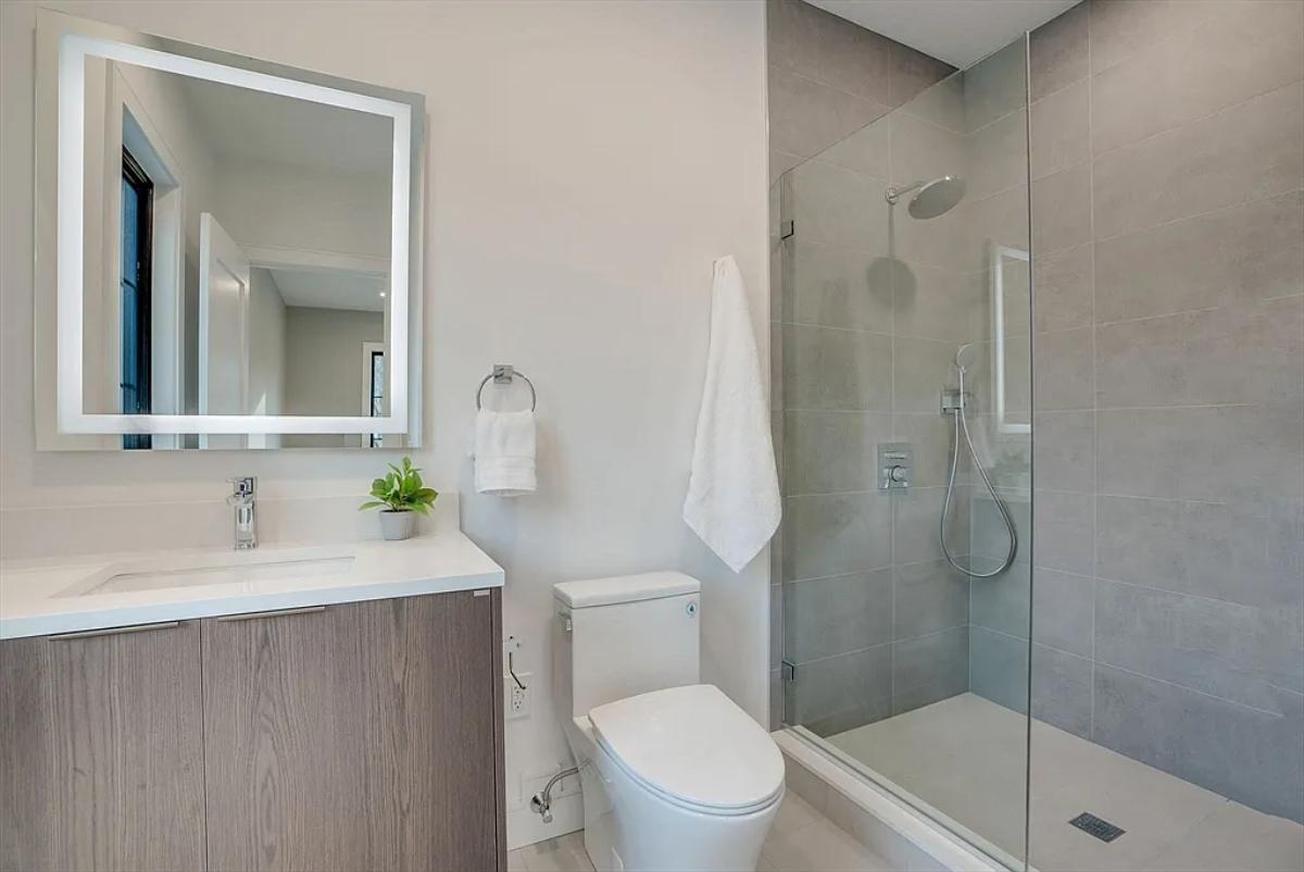 Bathroom with a sink, toilet and a walk-in shower.