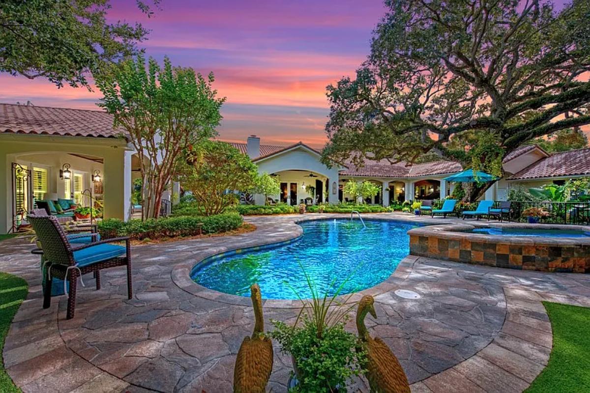 Rear view of the mansion with a pool.