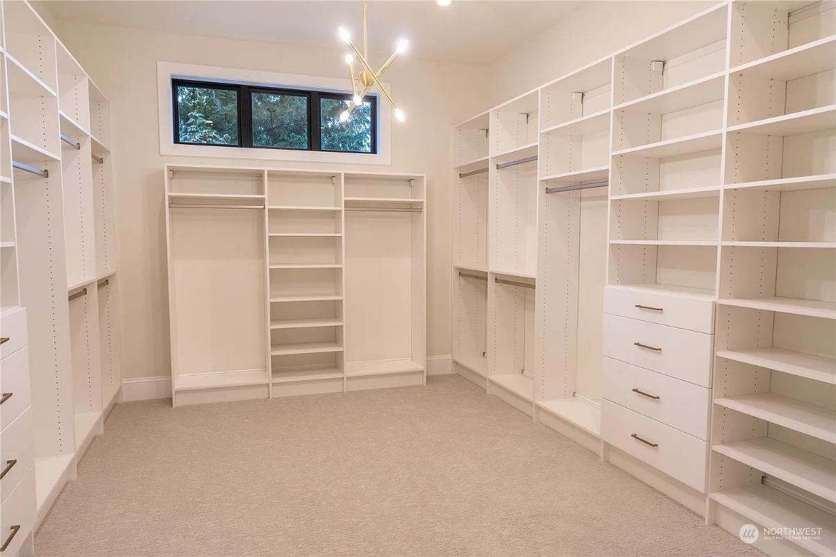 Walk-in closet with carpet flooring.