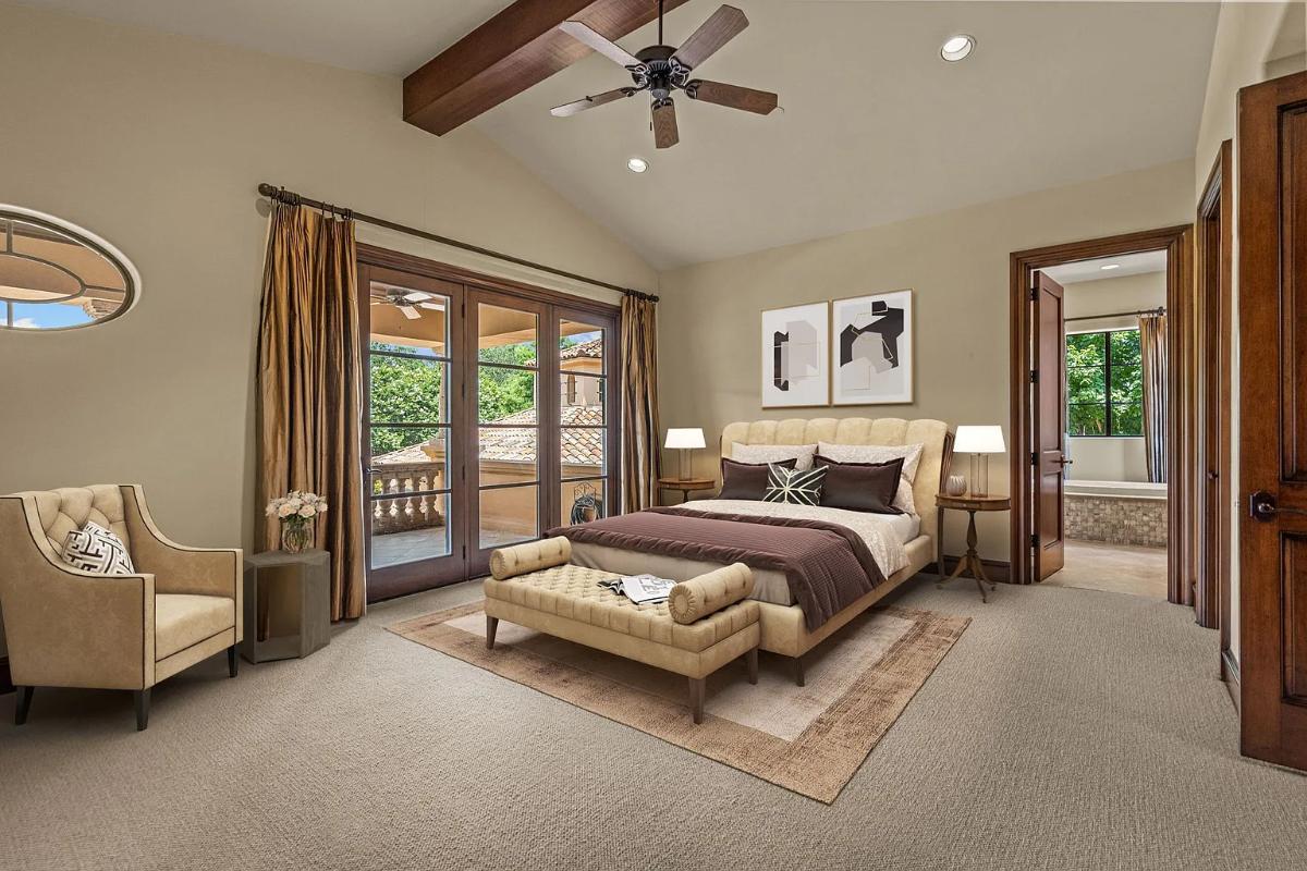 Bedroom with a large bed and carpet flooring.