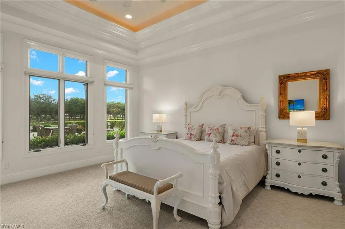 Bedroom with a large bed and carpet flooring.