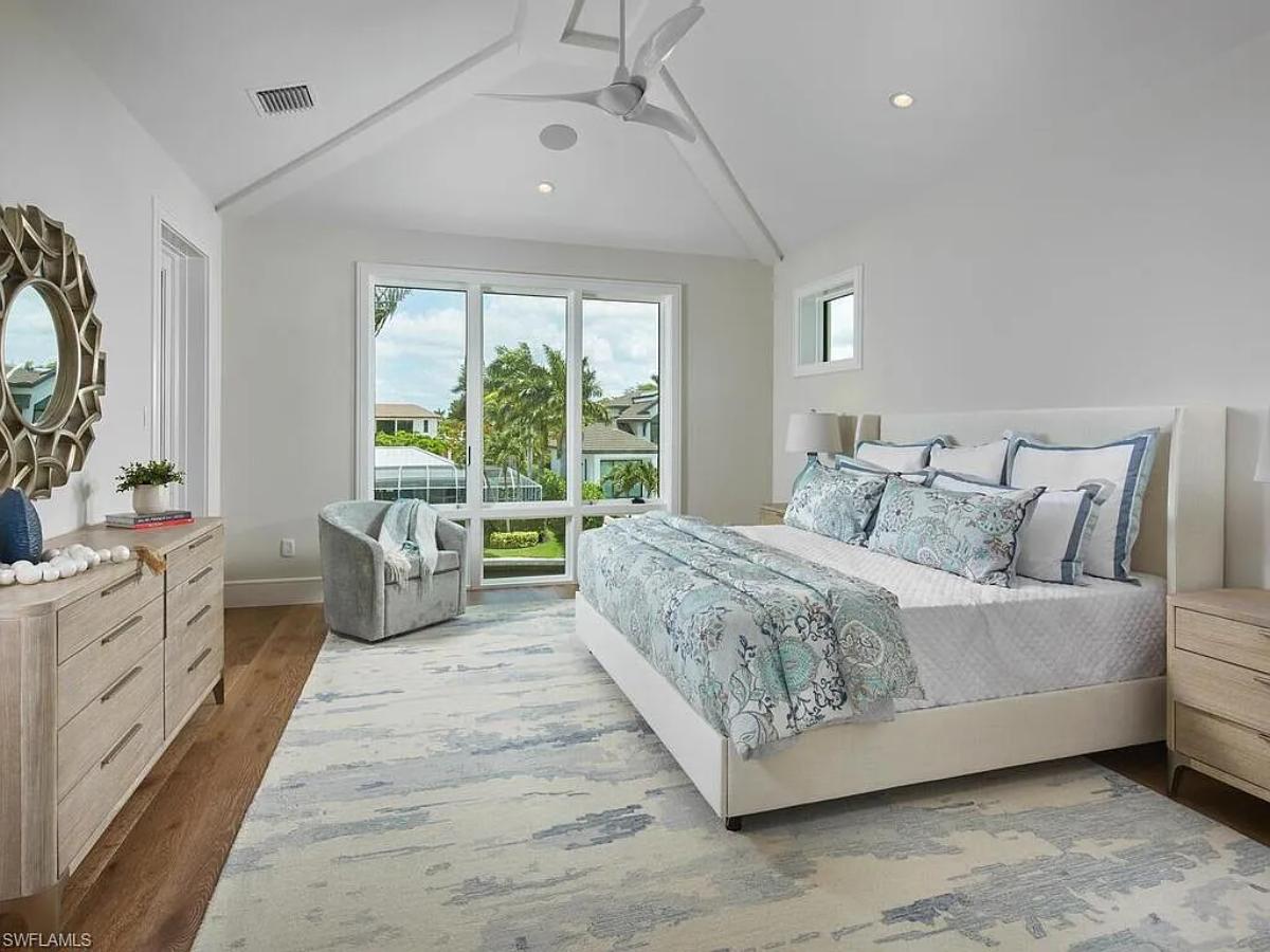 Bedroom with a large bed and hardwood floors.