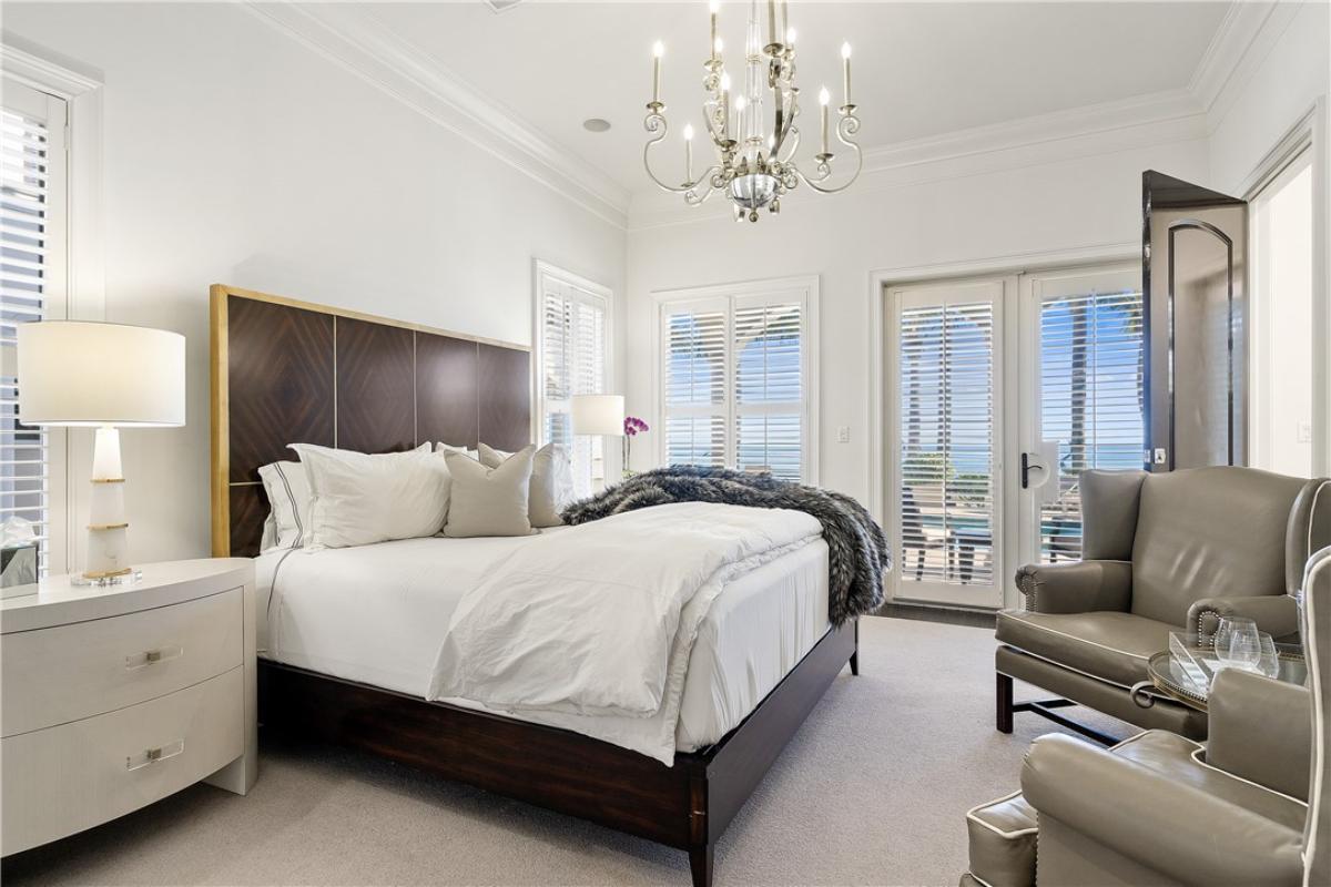 Bedroom with a large bed and a chandelier.