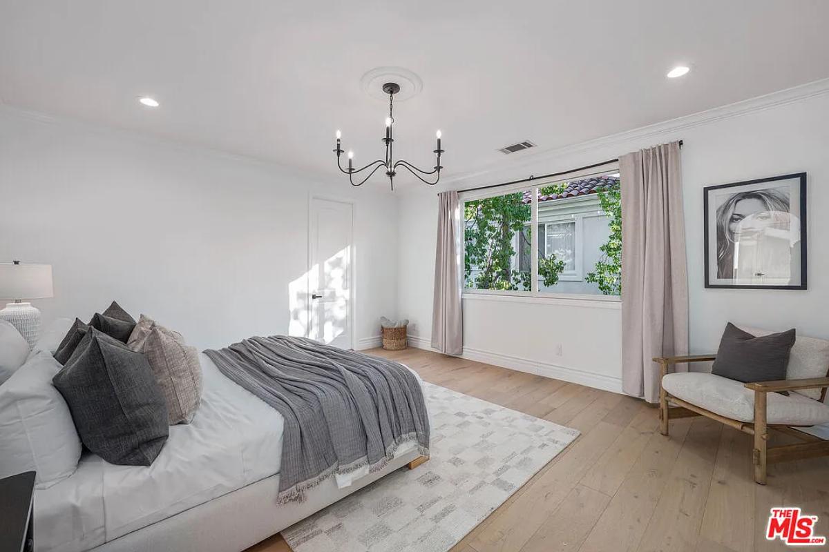 Bedroom with a large bed and hardwood floors.