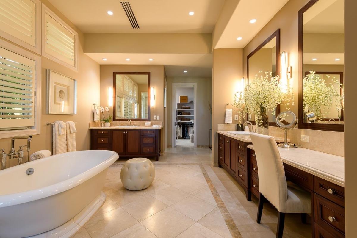 Bathroom with dual custom-made vanity and a soaking tub.