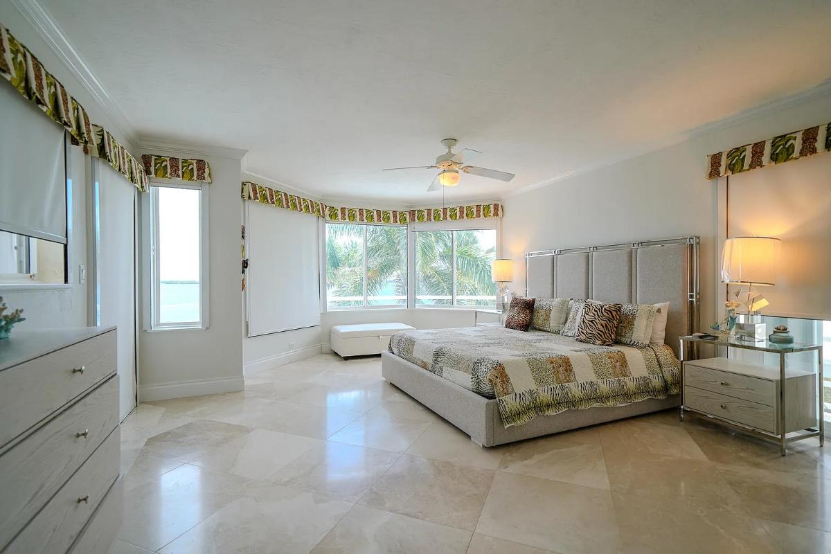 Bedroom with a large bed and glass windows.