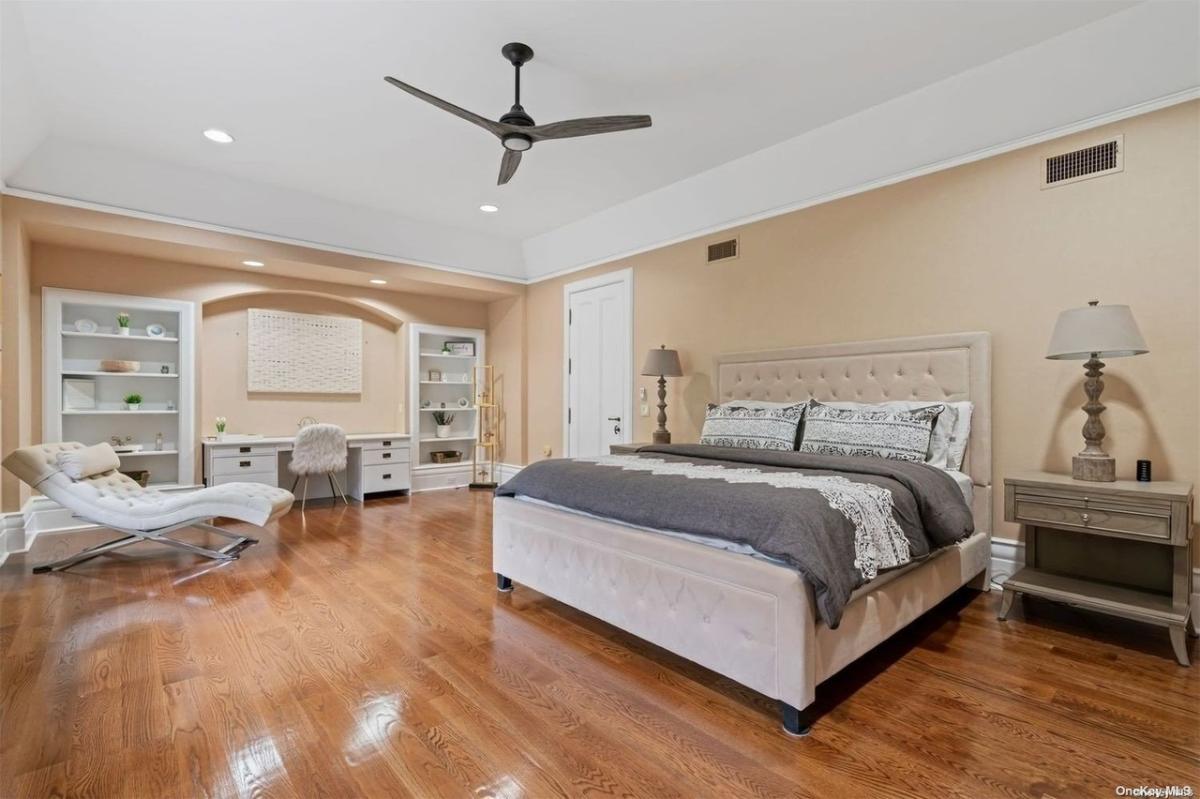 Bedroom with a large bed and hardwood floors.
