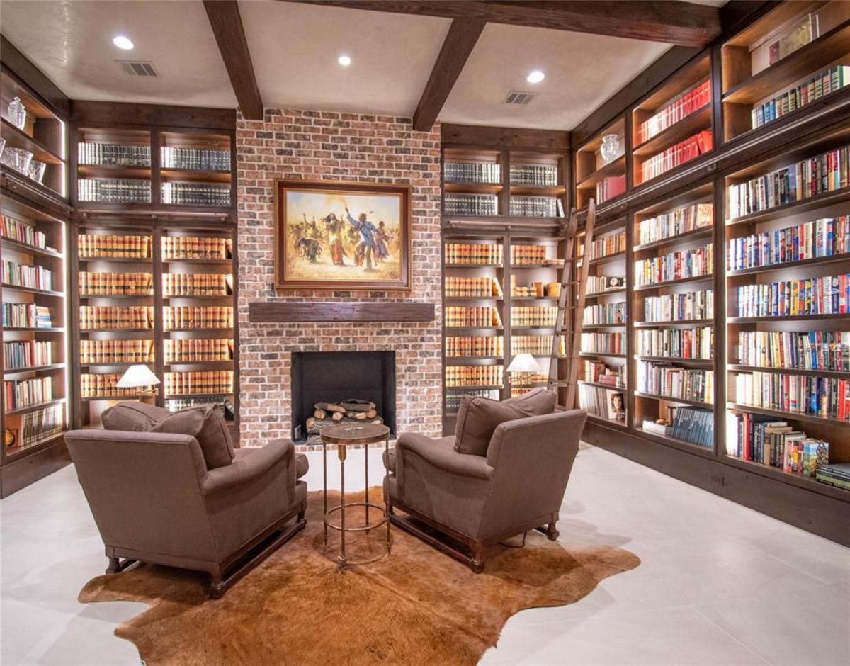 Library with a fireplace.