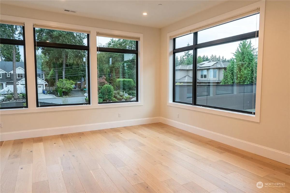 Bedroom with glass windows and hardwood floors.