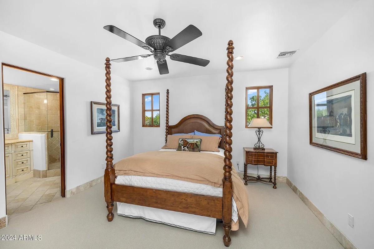 Bedroom with a large bed and carpet flooring.