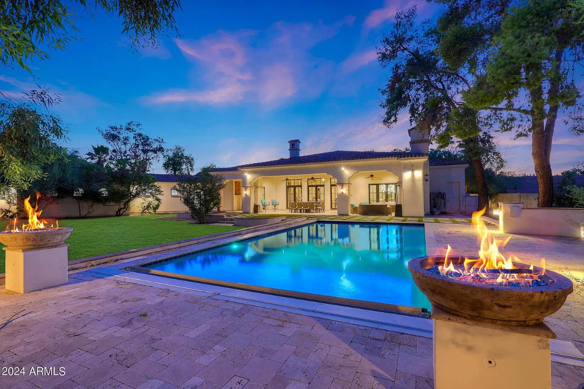 Rear view of the mansion with a pool.