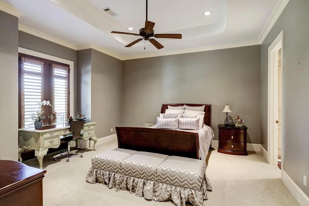 Bedroom with a large bed and carpet flooring.