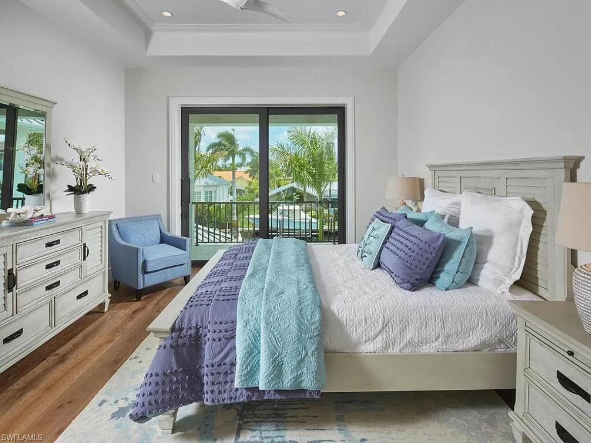 Bedroom with a large bed and hardwood floors.