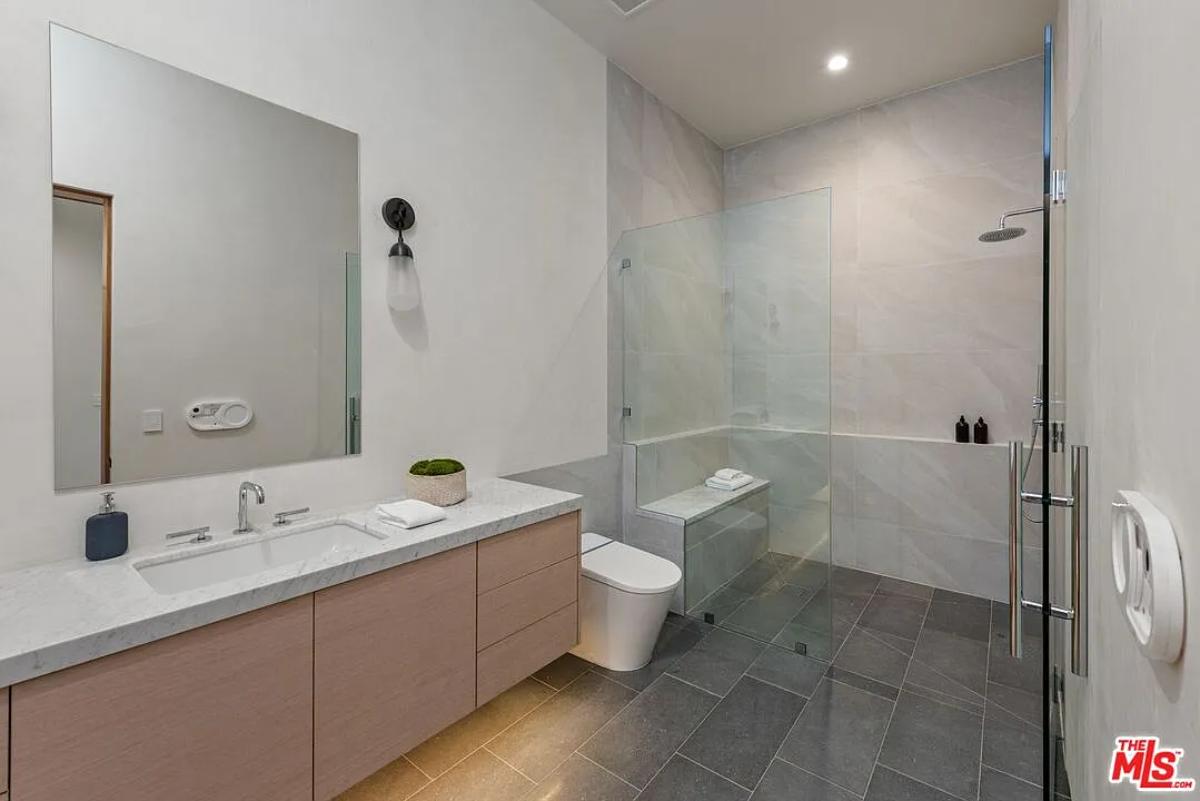 Bathroom with a sink, toilet and a walk-in shower.