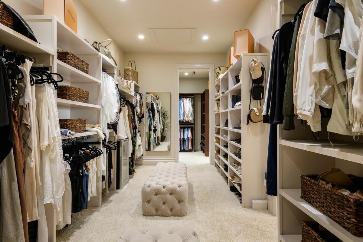 Walk-in closet with carpet flooring.