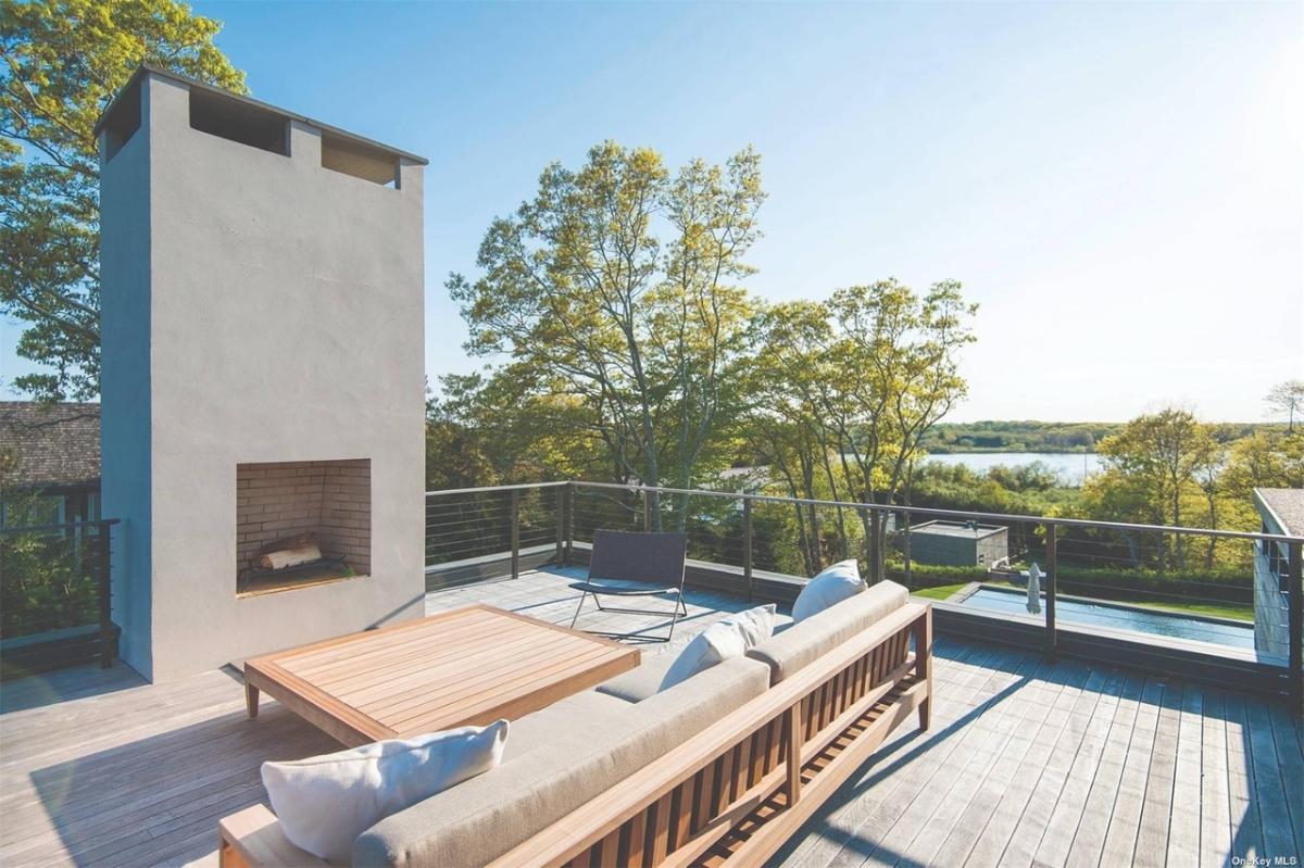 Terrace with a living space and a fireplace.
