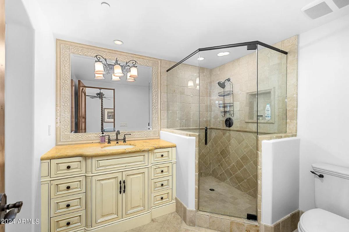 Bathroom with a sink, toilet and a walk-in shower.