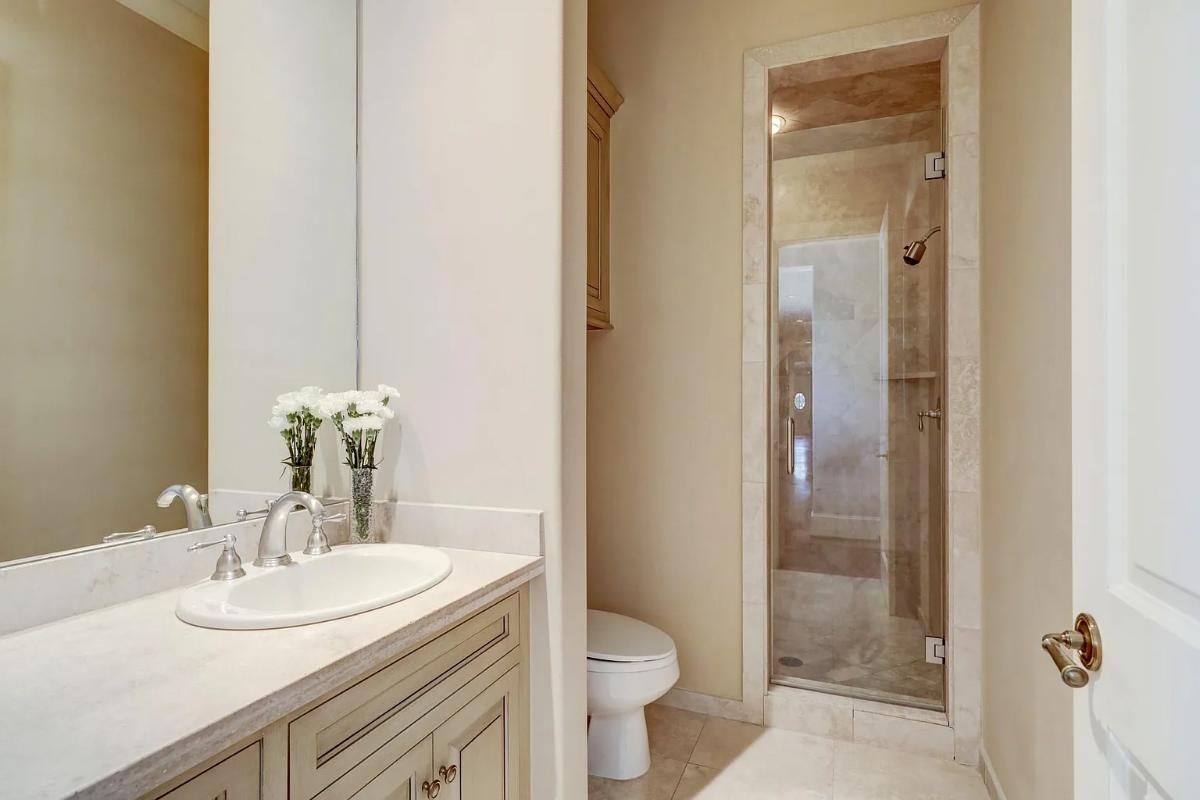 Bathroom with a sink, toilet and a walk-in shower.