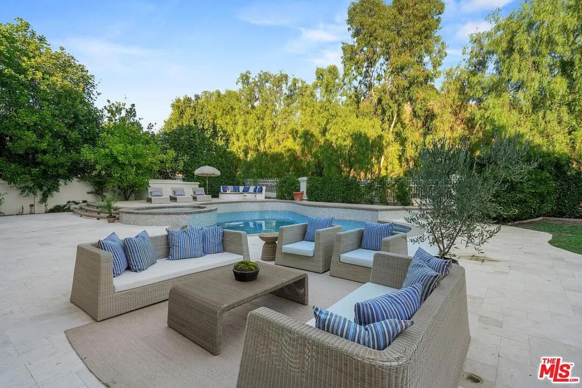 Outdoor living space adjacent to the pool.