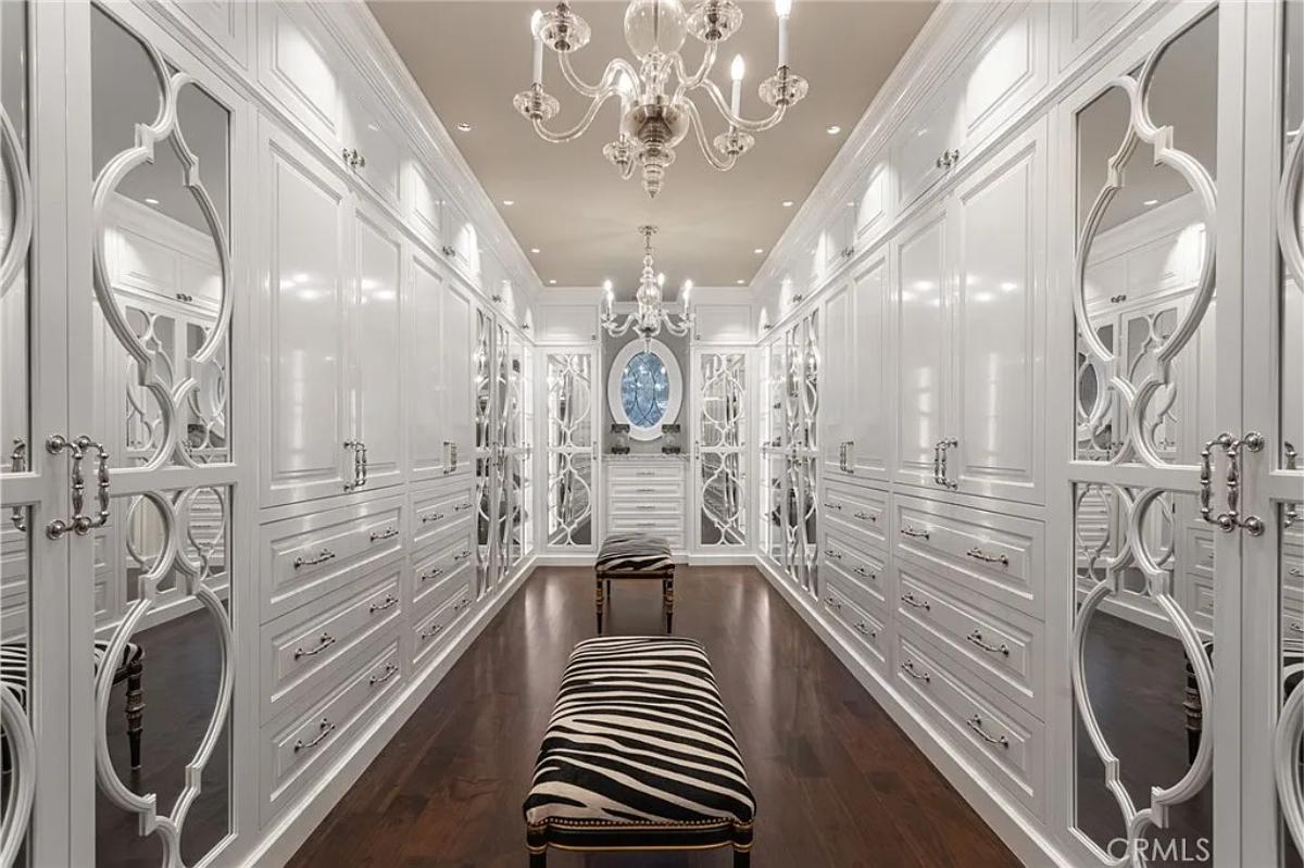Walk-in closet with chandeliers.