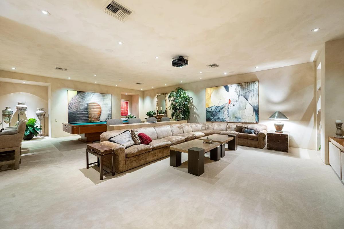 Recreation room with couches and a billiards table.