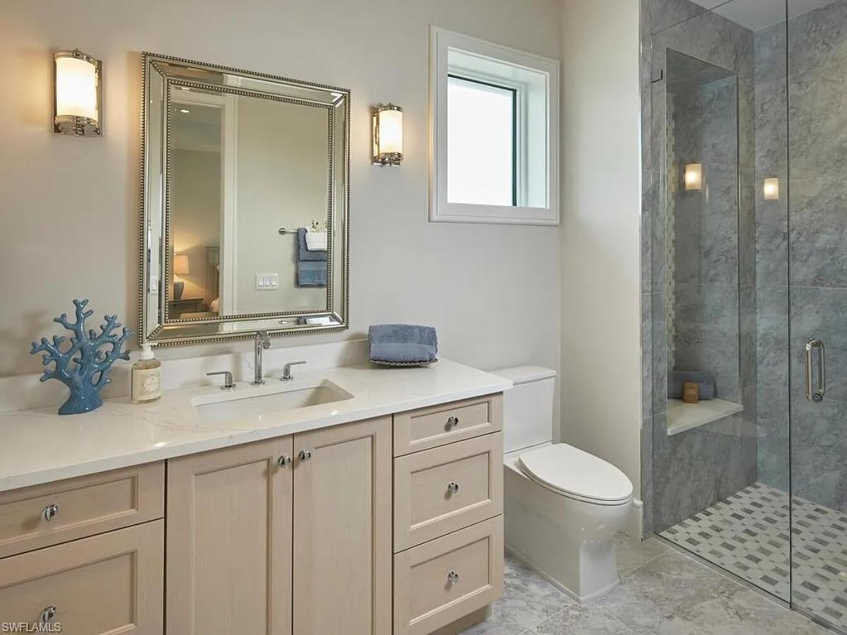 Bathroom with a sink, toilet and a walk-in shower.