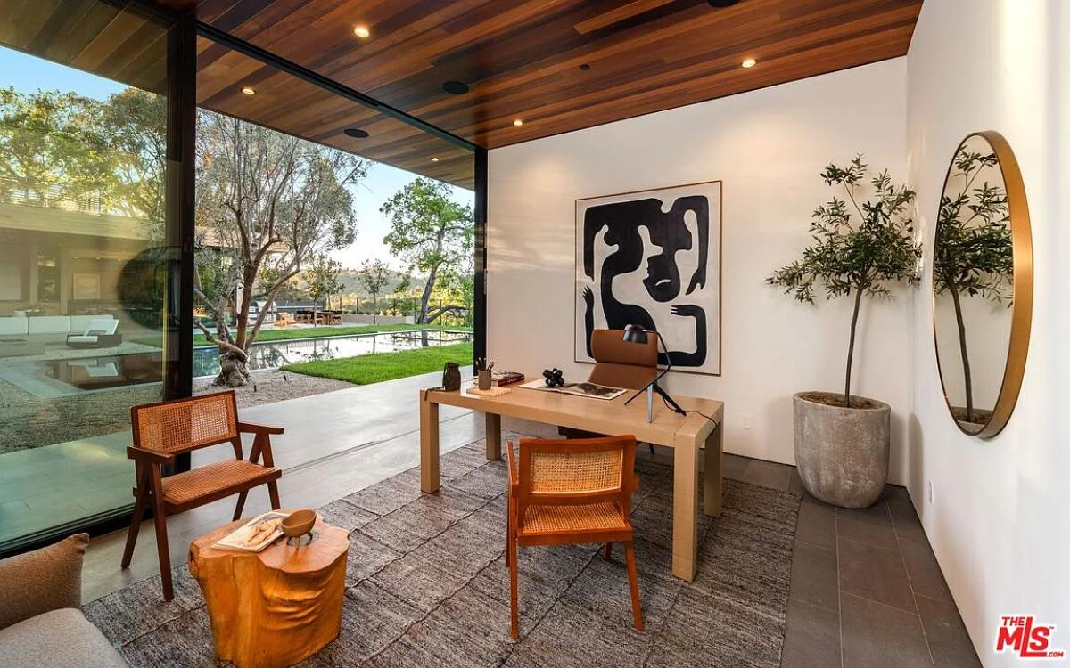 Home office with hardwood ceilings and sliding glass doors.