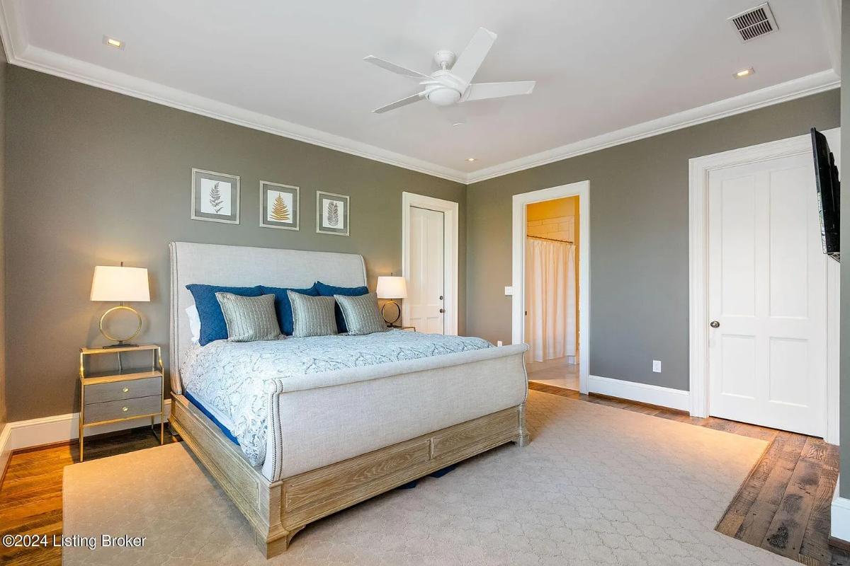 Bedroom with a large bed and hardwood floors.