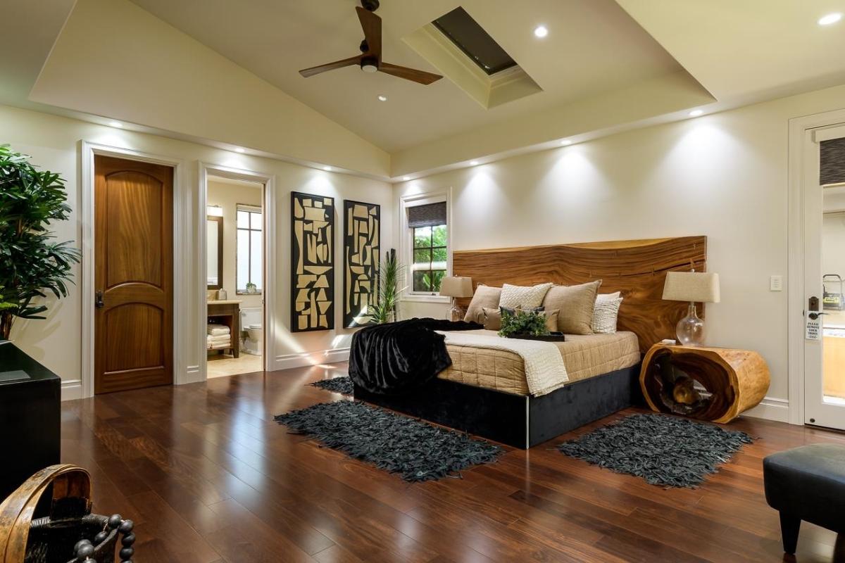 Bedroom with a large bed and hardwood floors.