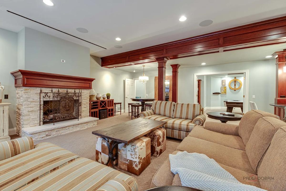 Recreation room with couches and a fireplace.
