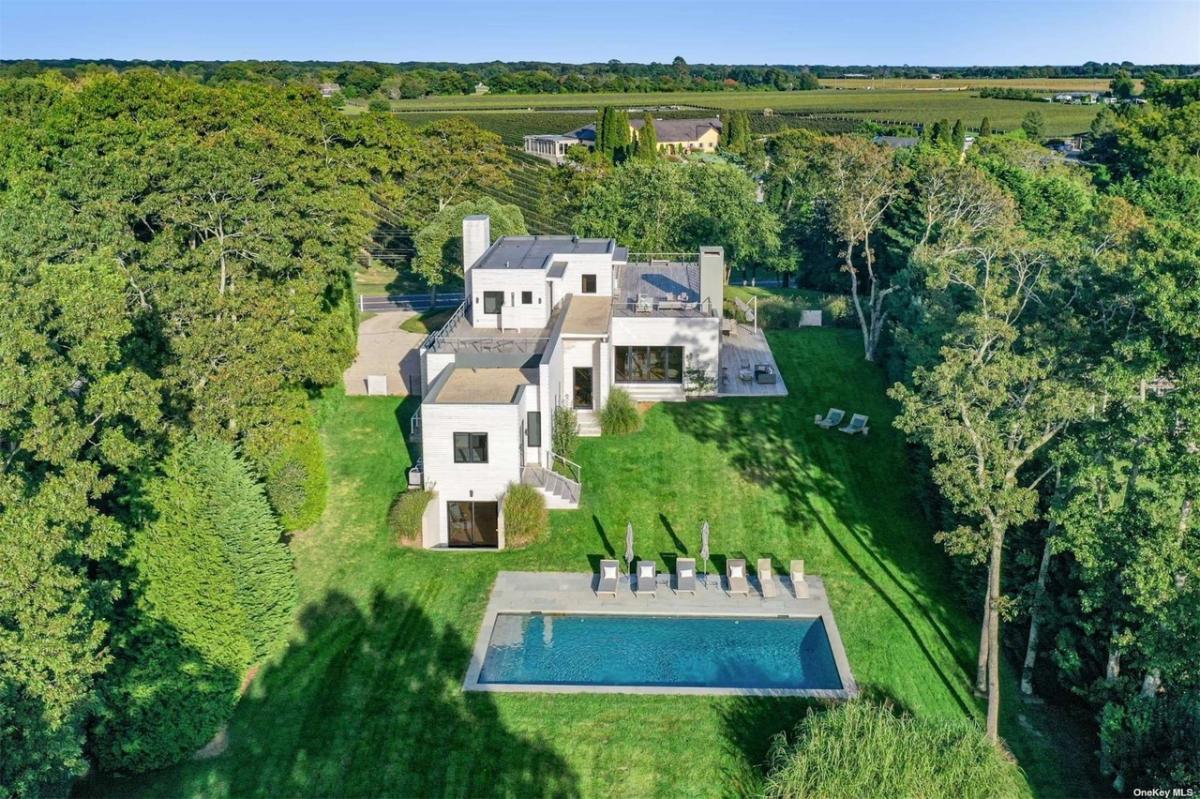 Aerial rear view of the mansion with a pool.
