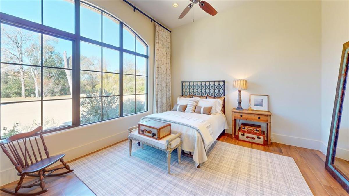Bedroom with a large bed and hardwood flooring.