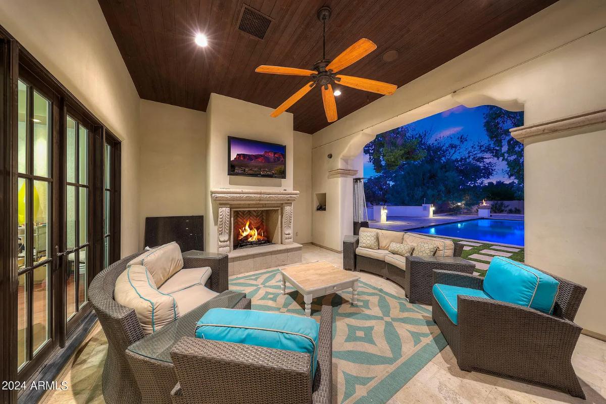 Outdoor living space with a fireplace.