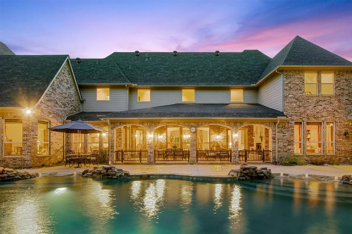 Rear view of the mansion with a pool.