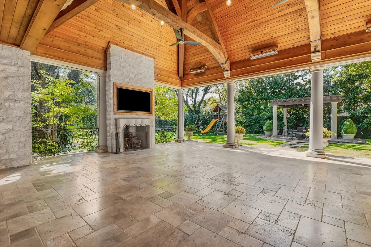 Indoor-outdoor living space with a fireplace.