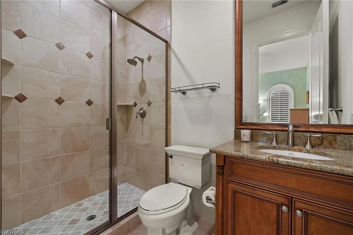 Bathroom with a sink, toilet and a walk-in shower.