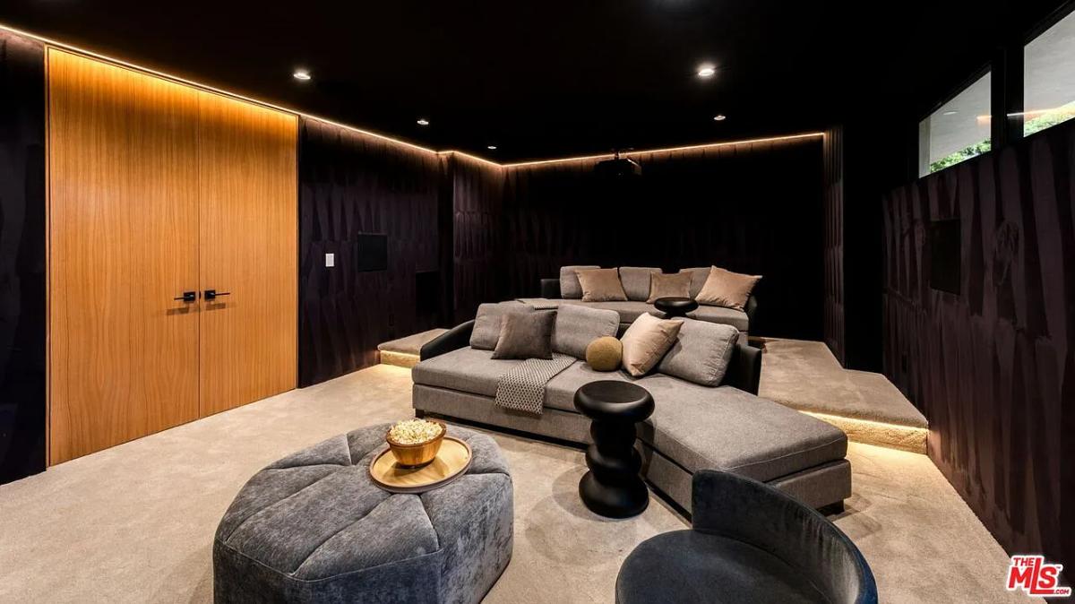 Home theater with couches and custom lighting.