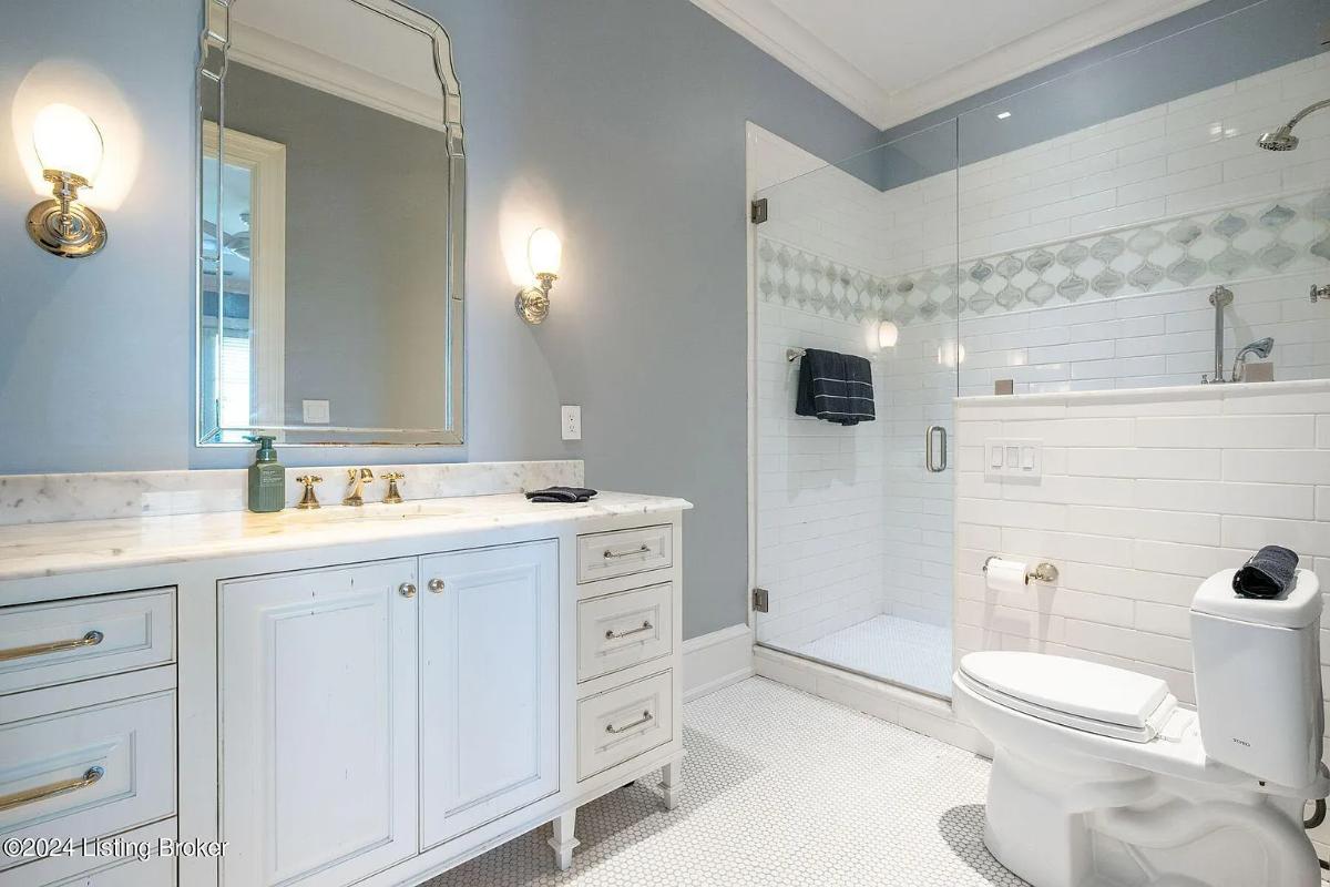 Bathroom with a sink, toilet and a walk-in shower.