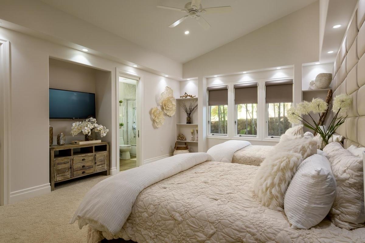 Bedroom with a large bed and carpet flooring.