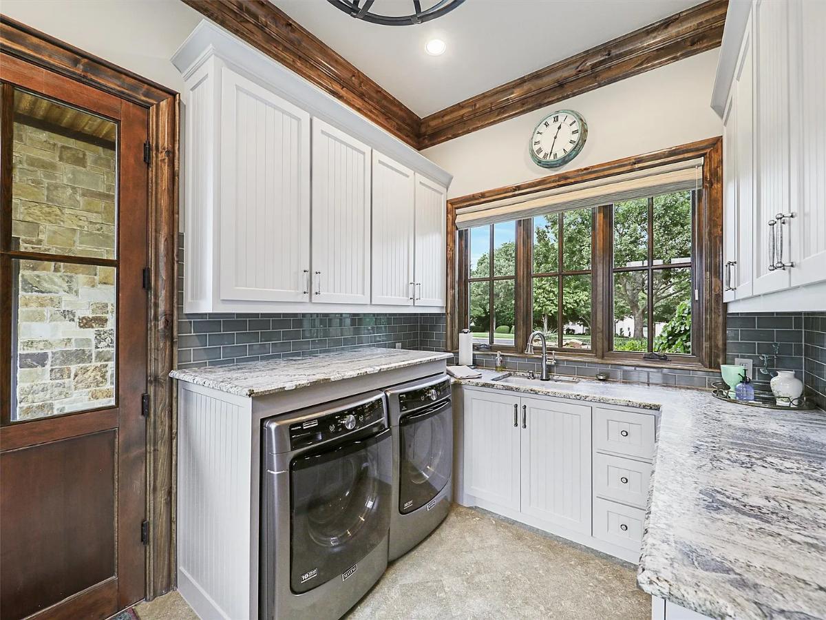 Laundry room with cabinets.