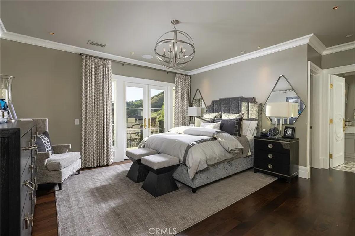 Bedroom with a large bed and hardwood floors.