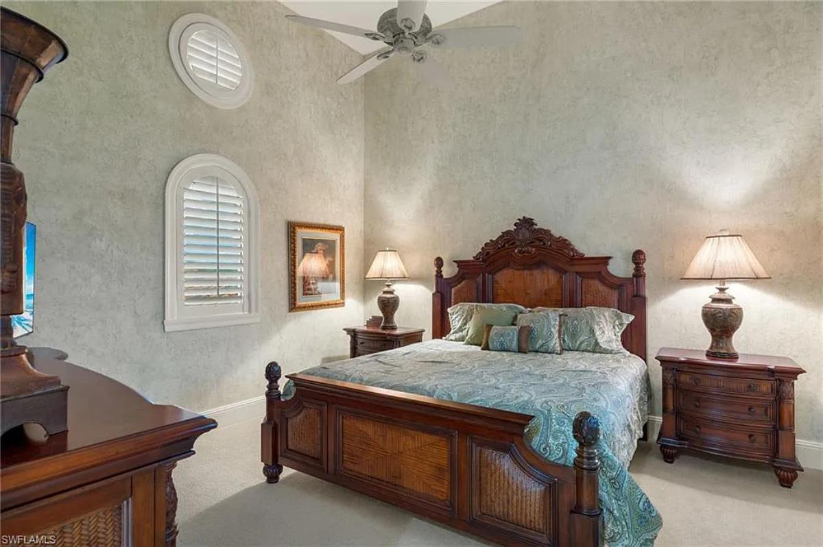 Bedroom with a large bed and carpet flooring.