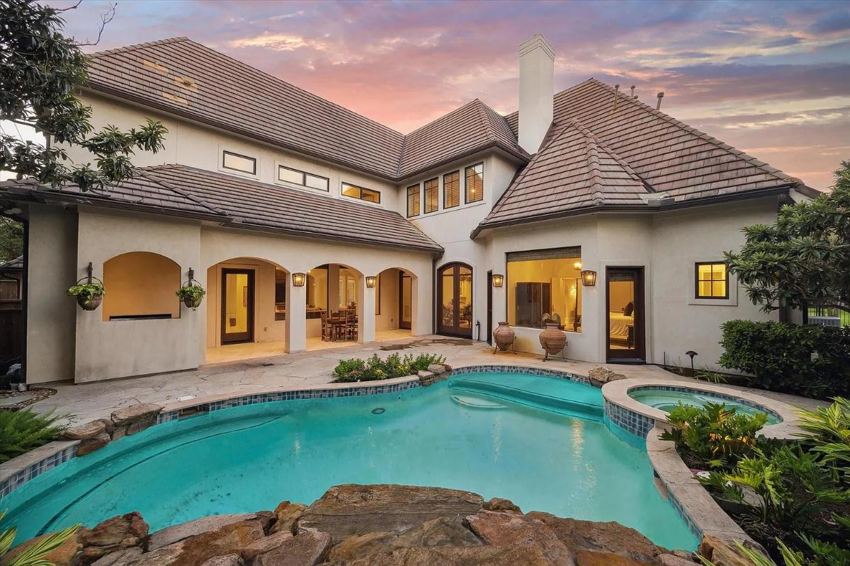 Rear view of the mansion with a pool.