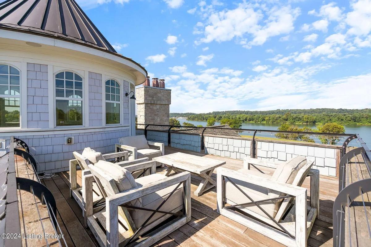 Rooftop deck with a table and chairs.