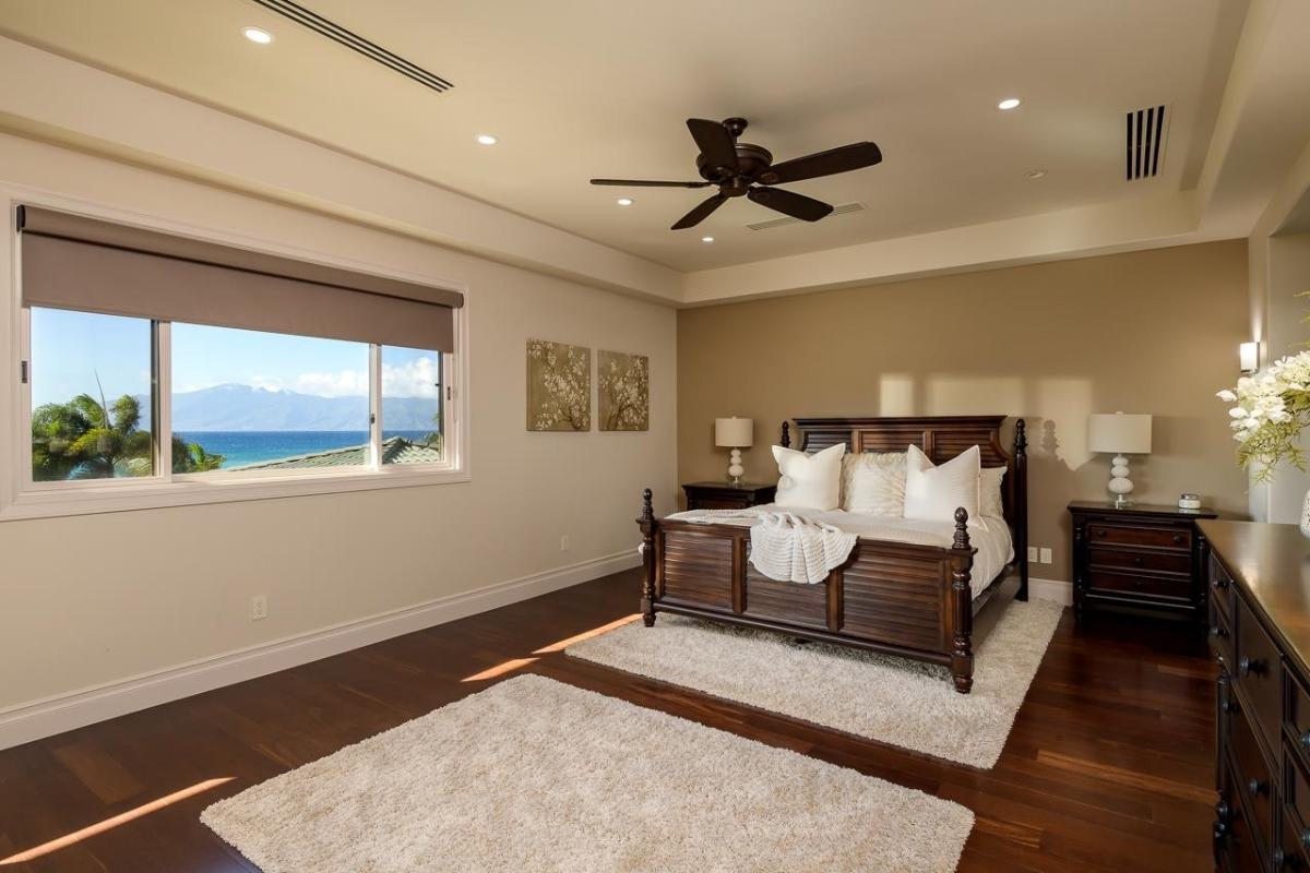 Bedroom with a large bed and hardwood floors.