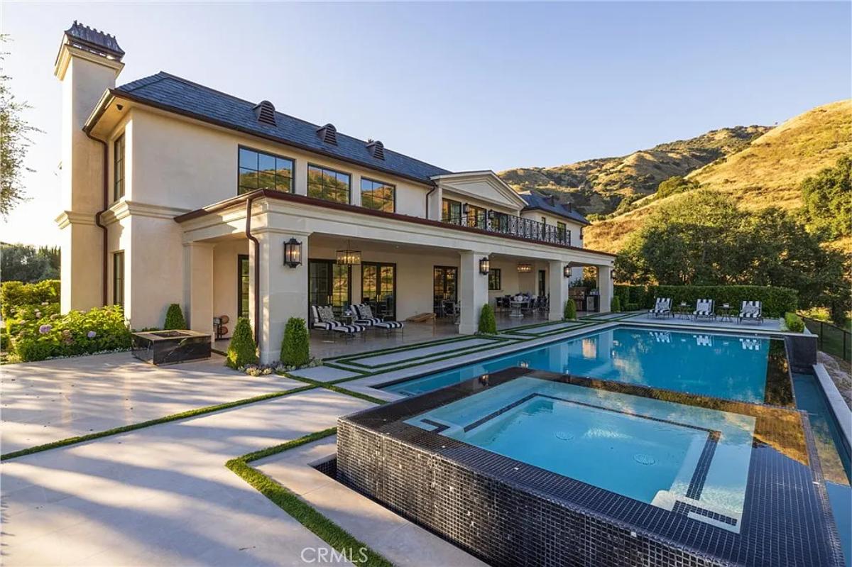 Rear view of the mansion with a pool.