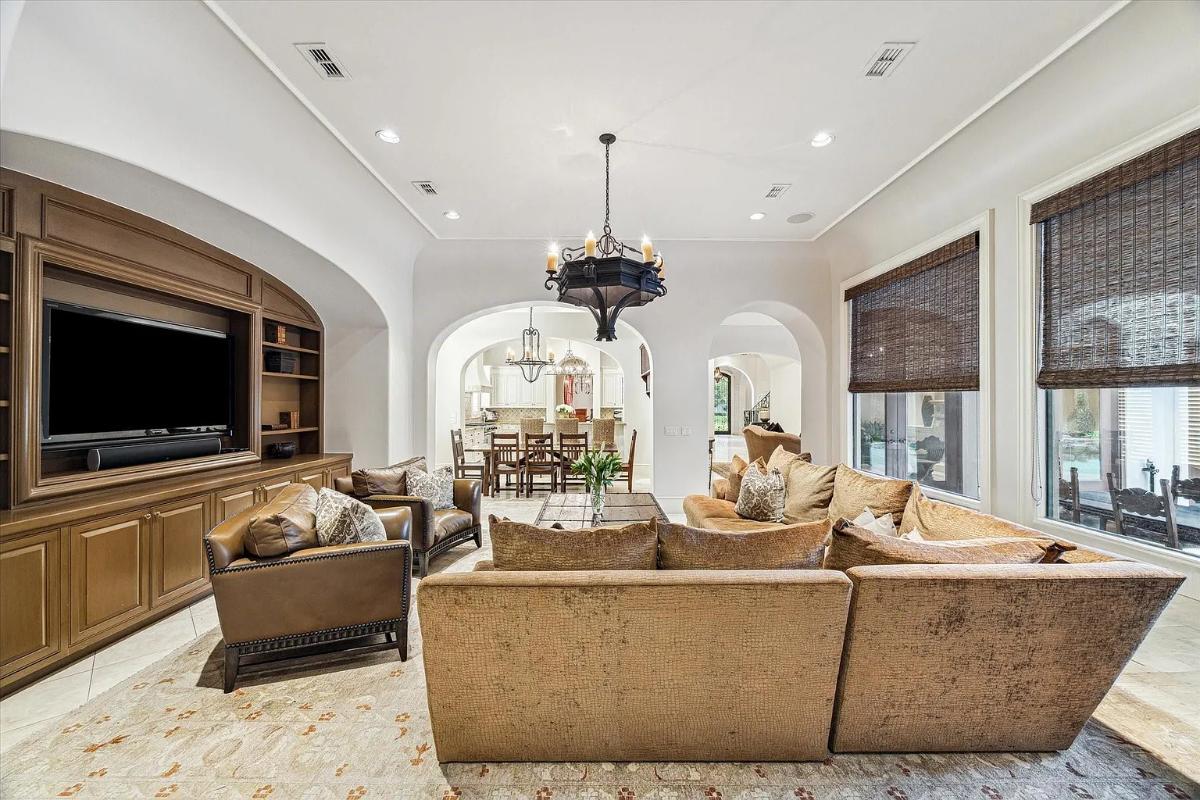 Living room with couches and a chandelier.