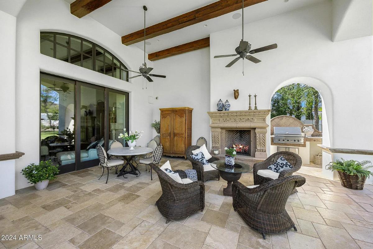 Outdoor living space with a fireplace.