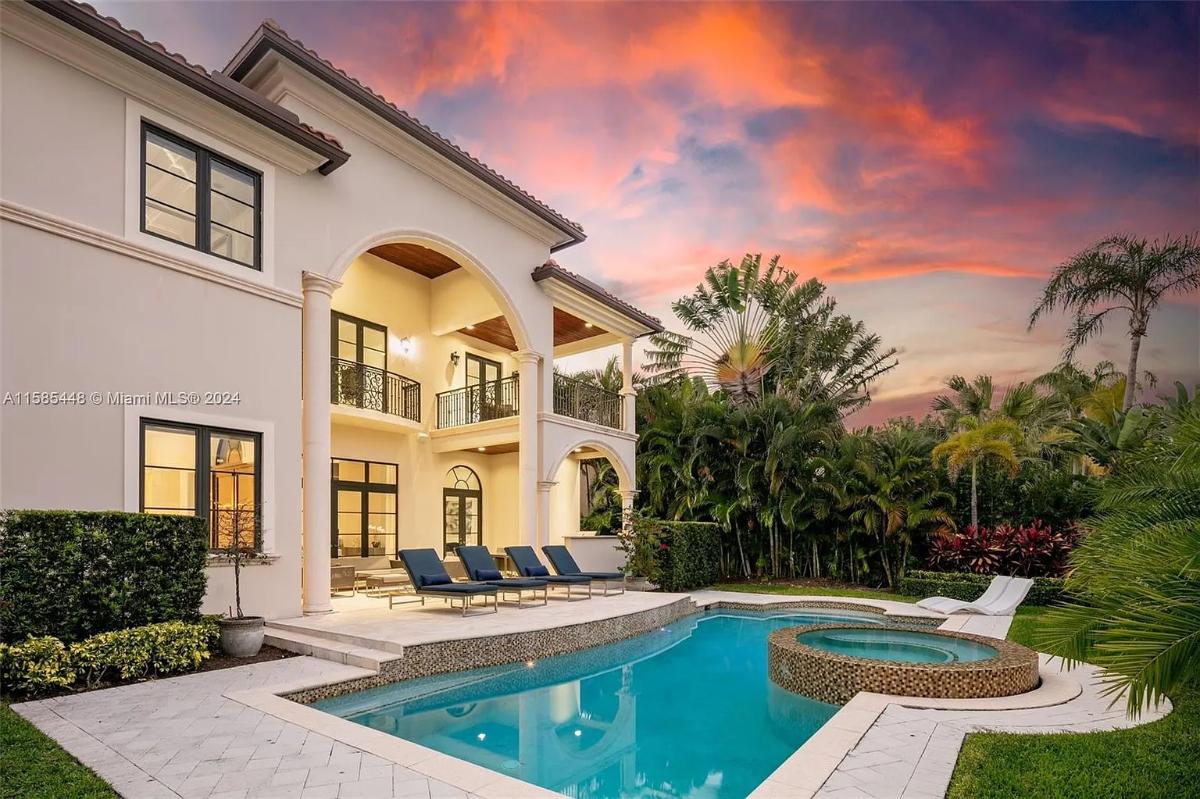 Rear view of the mansion with a pool.